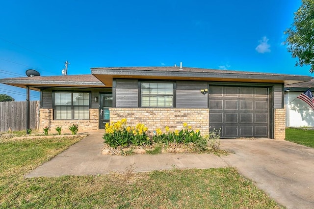 3101 Grove Dr, San Angelo, TX 76903 - view of front of house with brick siding, driveway, and a garage