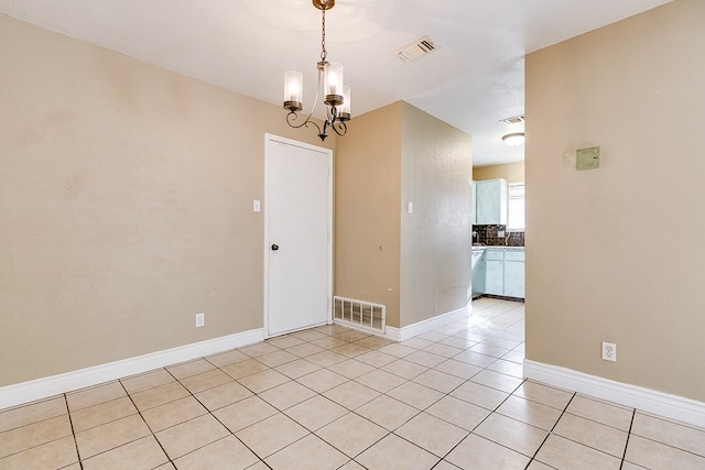 3101 Grove Dr, San Angelo, TX 76903 - empty room with a chandelier and light tile patterned flooring