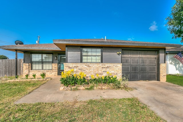 3101 Grove Dr, San Angelo, TX 76903 - view of front of home featuring brick siding, driveway, and an attached garage