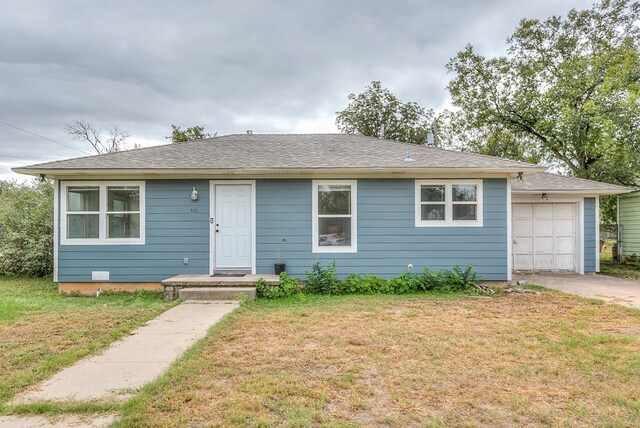 view of front of home with a garage and a front lawn