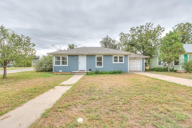 view of front of home featuring a garage and a front yard