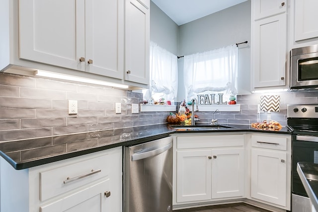 3406 Twin Mountain Dr, San Angelo, TX 76904 - kitchen featuring stainless steel appliances, dark countertops, and white cabinets