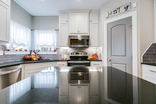 3406 Twin Mountain Dr, San Angelo, TX 76904 - kitchen with appliances with stainless steel finishes, tasteful backsplash, white cabinets, and dark stone countertops