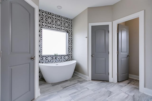 3406 Twin Mountain Dr, San Angelo, TX 76904 - bathroom featuring a freestanding bath and baseboards