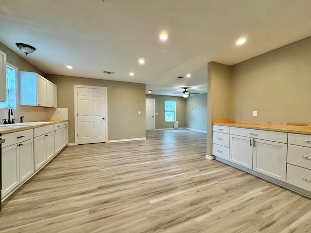 919 E 20th St, San Angelo, TX 76903 - kitchen with a sink, light wood-style floors, recessed lighting, baseboards, and ceiling fan