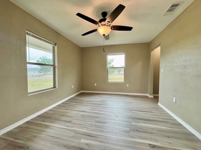 919 E 20th St, San Angelo, TX 76903 - unfurnished room with a textured wall, ceiling fan, light wood finished floors, and baseboards
