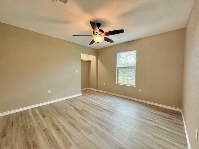 919 E 20th St, San Angelo, TX 76903 - spare room featuring ceiling fan, light wood finished floors, and baseboards
