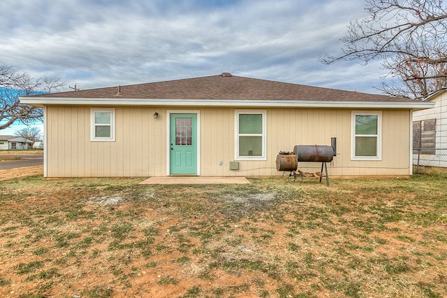 back of property featuring a yard