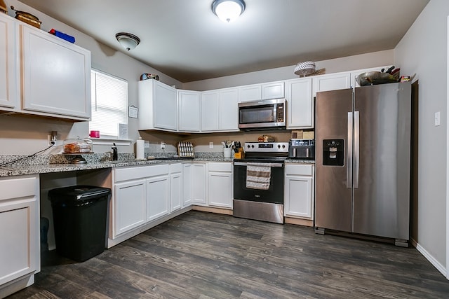 kitchen featuring appliances with stainless steel finishes, sink, white cabinets, and light stone counters