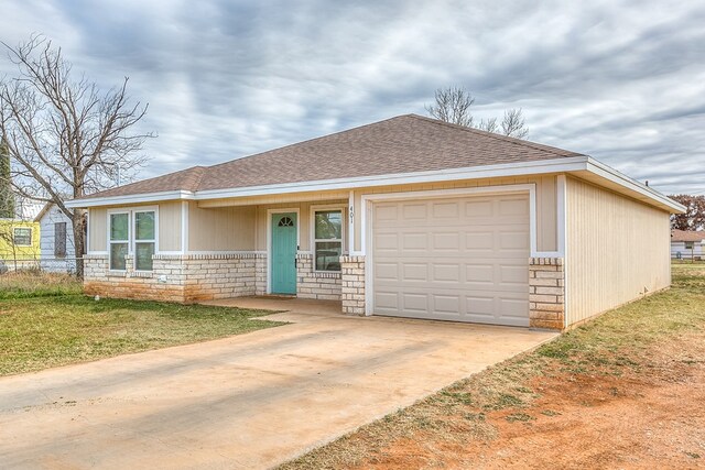 single story home featuring a garage and a front lawn