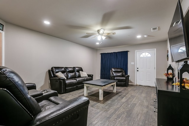 living room with wood-type flooring and ceiling fan