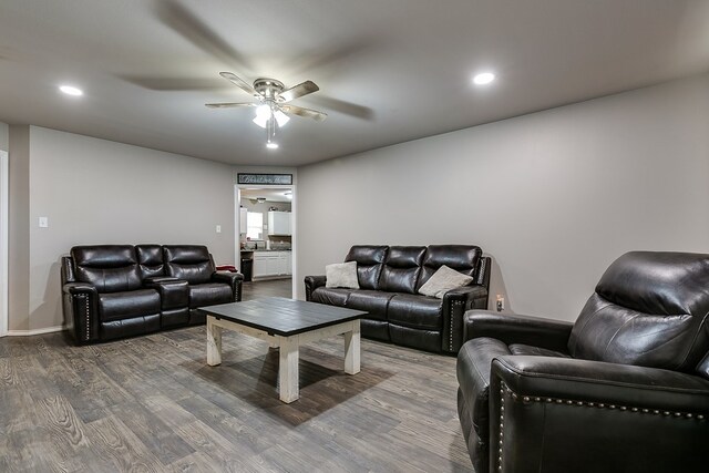 living room with wood-type flooring and ceiling fan