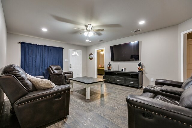 living room featuring hardwood / wood-style floors and ceiling fan