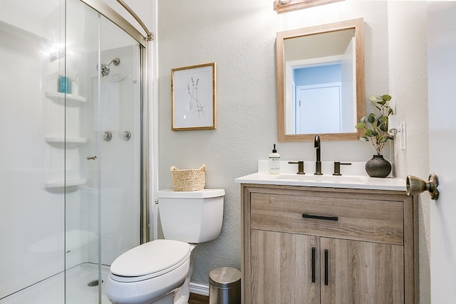 bathroom with walk in shower, vanity, and toilet