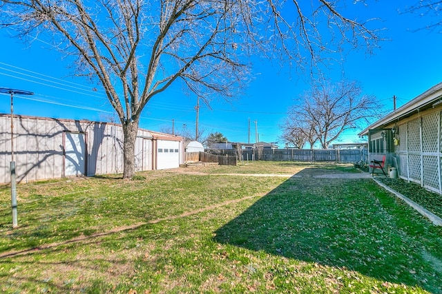 view of yard with a garage and an outdoor structure