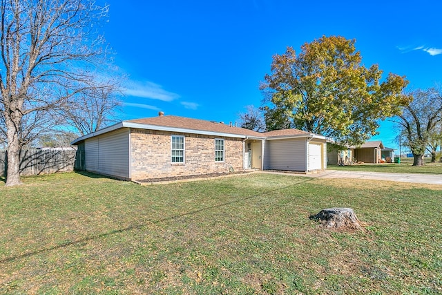 ranch-style house with a garage and a front lawn