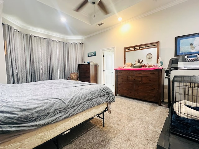 bedroom with light carpet, a tray ceiling, ornamental molding, and ceiling fan