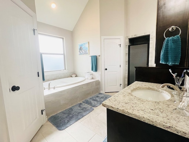 bathroom with tiled tub, vanity, tile patterned flooring, and high vaulted ceiling