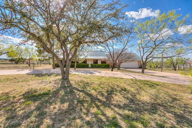 261 Edinburgh Rd, San Angelo, TX 76901 - single story home with concrete driveway, a front lawn, and metal roof