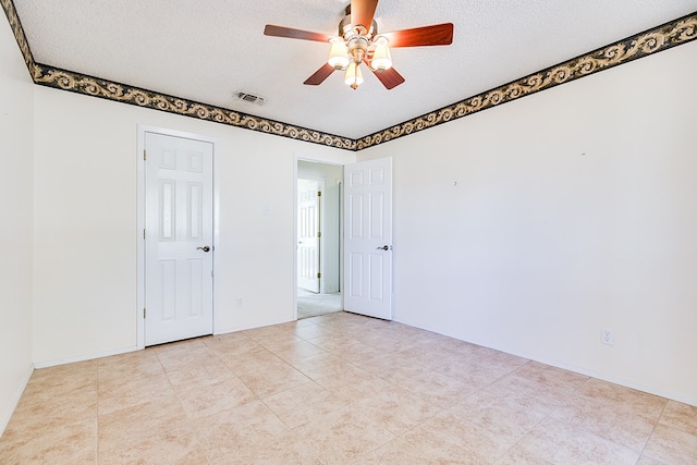 261 Edinburgh Rd, San Angelo, TX 76901 - empty room with baseboards, a textured ceiling, visible vents, and a ceiling fan