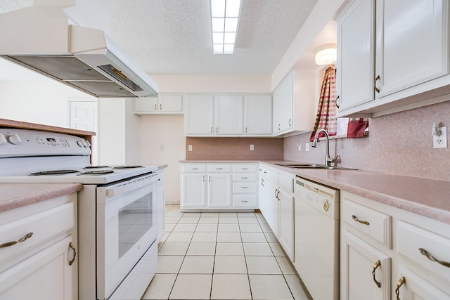 261 Edinburgh Rd, San Angelo, TX 76901 - kitchen featuring a sink, white cabinetry, custom exhaust hood, light tile patterned floors, and white appliances