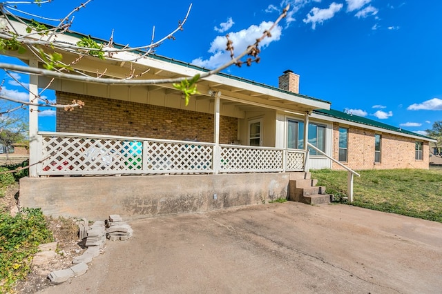 261 Edinburgh Rd, San Angelo, TX 76901 - back of house with brick siding and a chimney