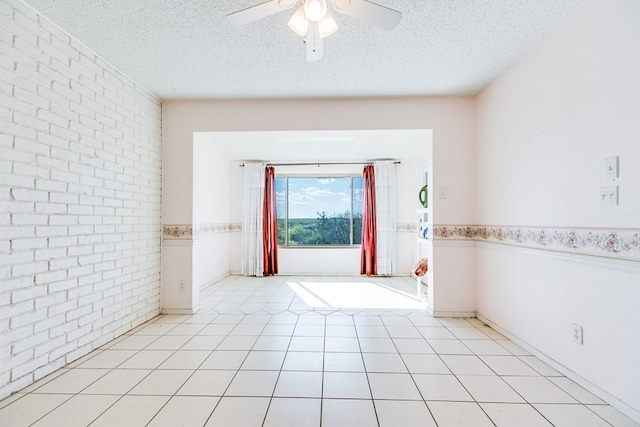 261 Edinburgh Rd, San Angelo, TX 76901 - spare room featuring ceiling fan, brick wall, and a textured ceiling