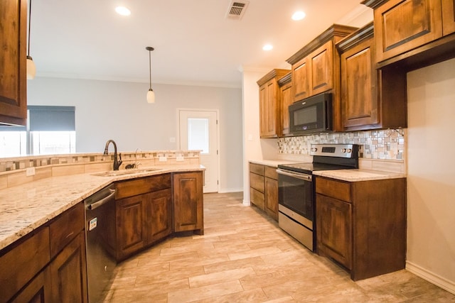 5806 Willeke Dr, San Angelo, TX 76904 - kitchen featuring appliances with stainless steel finishes, a sink, decorative backsplash, crown molding, and light stone countertops