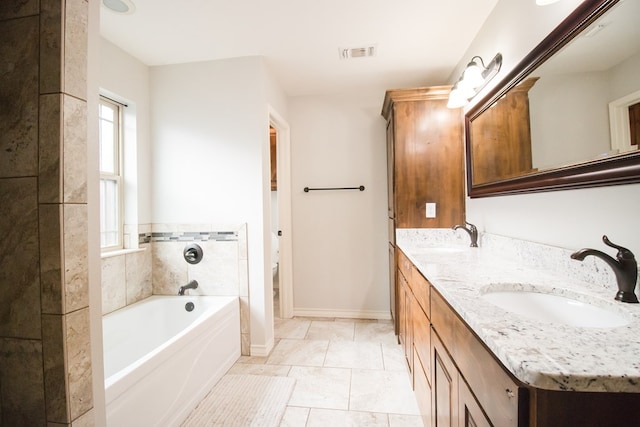 5806 Willeke Dr, San Angelo, TX 76904 - bathroom featuring a bath, double vanity, baseboards, toilet, and tile patterned flooring