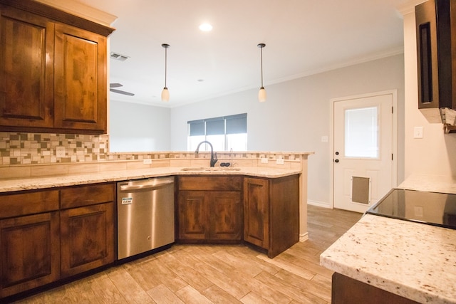 5806 Willeke Dr, San Angelo, TX 76904 - kitchen featuring stainless steel dishwasher, a sink, a peninsula, backsplash, and light wood-style floors