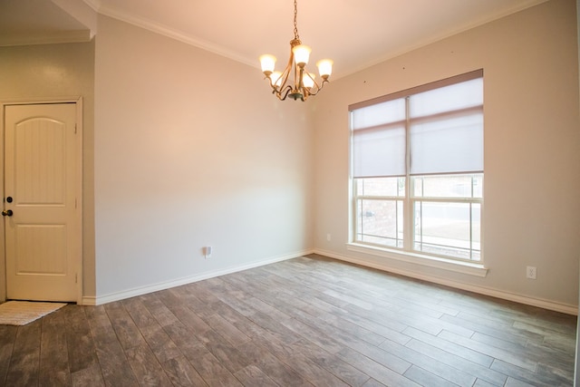 5806 Willeke Dr, San Angelo, TX 76904 - spare room featuring a chandelier, wood finished floors, ornamental molding, and baseboards
