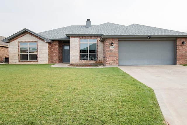 5806 Willeke Dr, San Angelo, TX 76904 - view of front facade with a shingled roof, brick siding, an attached garage, a front lawn, and concrete driveway