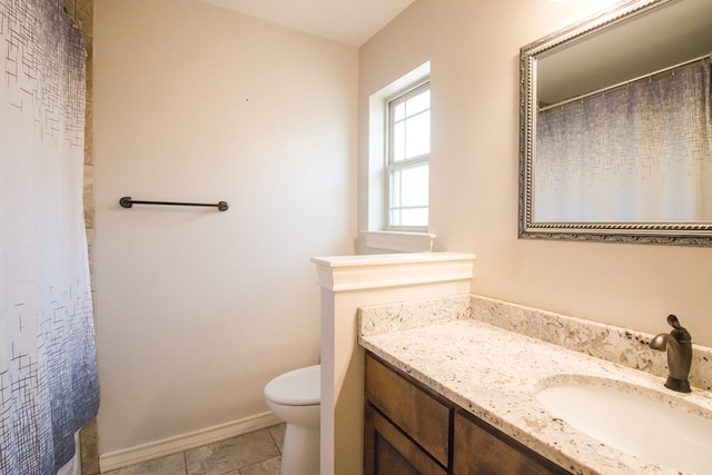 5806 Willeke Dr, San Angelo, TX 76904 - bathroom featuring vanity, toilet, tile patterned floors, baseboards, and a shower with curtain