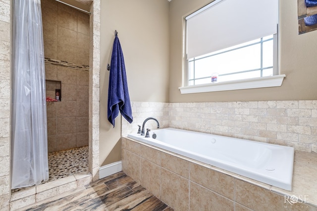 3504 Badger Ct, San Angelo, TX 76901 - full bathroom with a bath, tiled shower, and wood finished floors