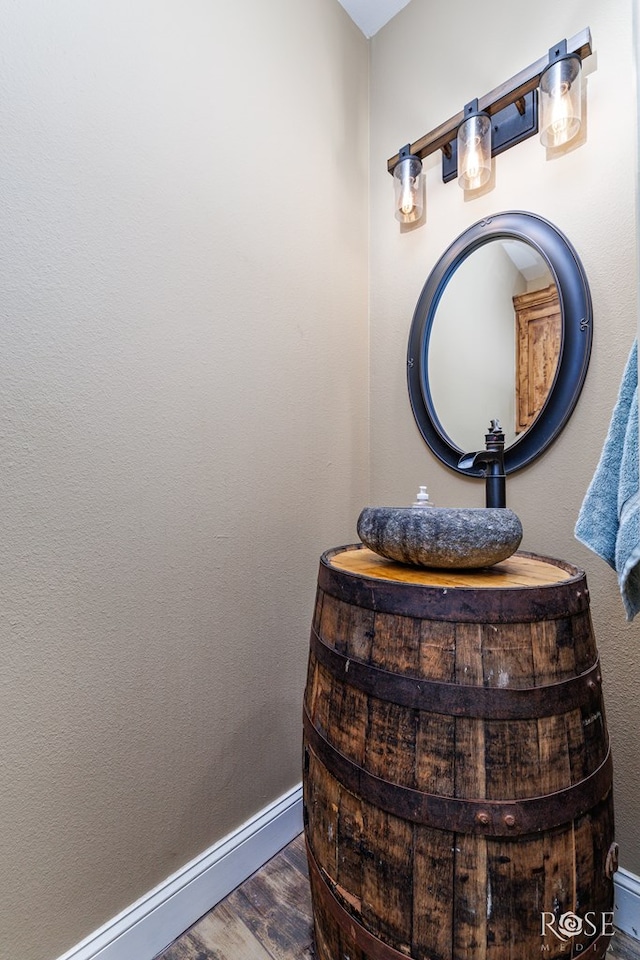 3504 Badger Ct, San Angelo, TX 76901 - bathroom view of wood finished floors, vanity, and baseboards