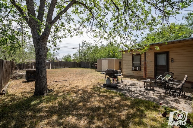 view of yard featuring a patio and a storage unit