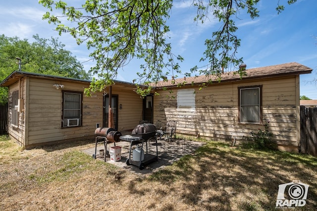 rear view of house featuring a patio and a lawn