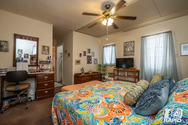 bedroom featuring ceiling fan and dark colored carpet