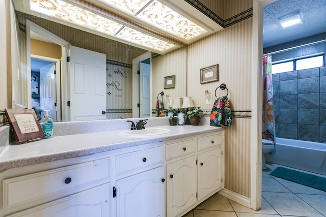 full bathroom with shower / tub combo with curtain, vanity, toilet, tile patterned floors, and a textured ceiling