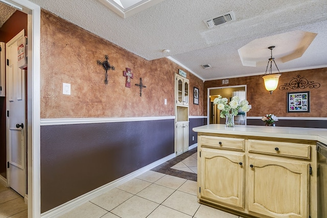 kitchen featuring ornamental molding, decorative light fixtures, a textured ceiling, and light tile patterned floors