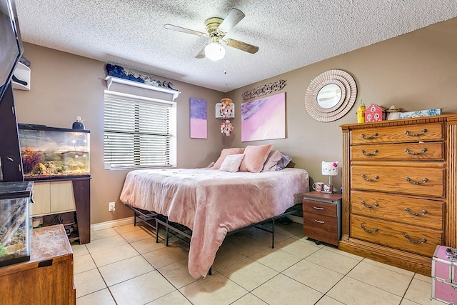 bedroom featuring ceiling fan, a textured ceiling, and light tile patterned flooring