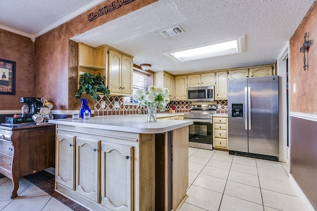 kitchen with light tile patterned floors, backsplash, stainless steel appliances, a textured ceiling, and light brown cabinets