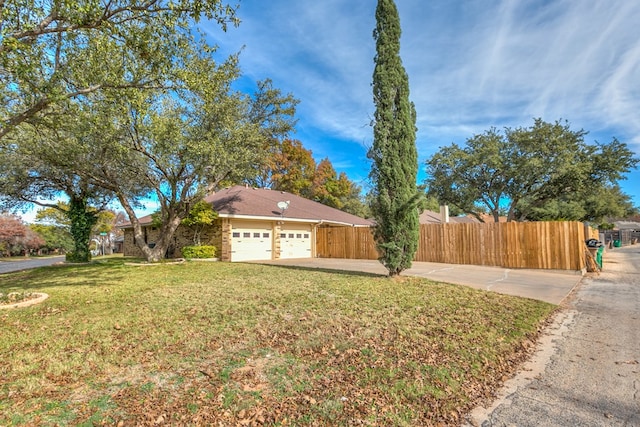 exterior space featuring a garage and a front lawn