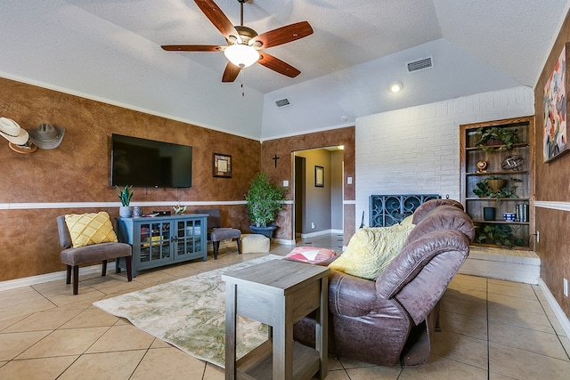 living room featuring lofted ceiling, light tile patterned floors, a textured ceiling, and a fireplace