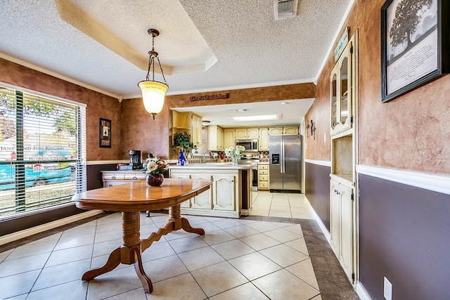 dining space featuring light tile patterned floors, a tray ceiling, ornamental molding, and a textured ceiling