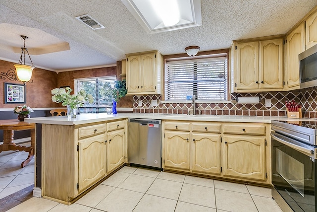 kitchen with sink, light brown cabinets, kitchen peninsula, pendant lighting, and stainless steel appliances