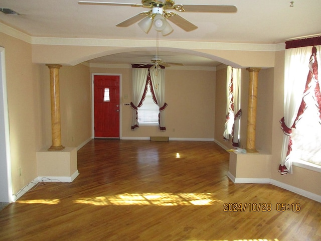 foyer entrance featuring hardwood / wood-style floors, crown molding, decorative columns, and ceiling fan