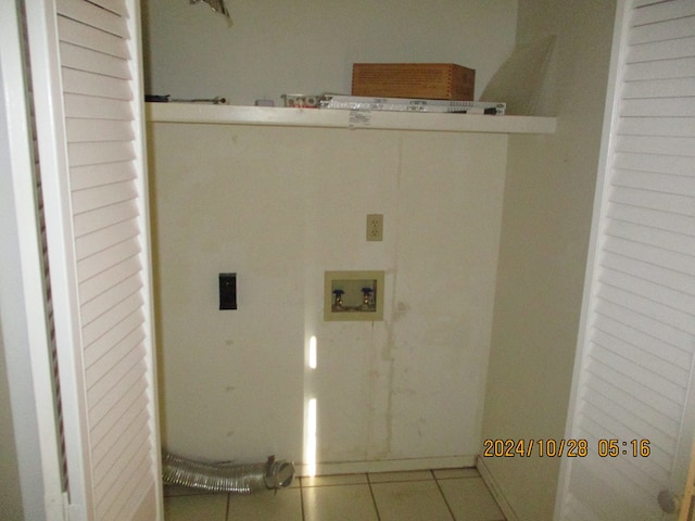 laundry area with washer hookup and tile patterned flooring