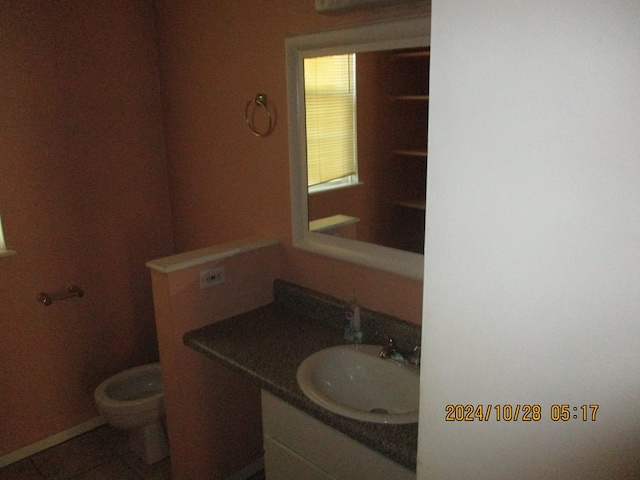 bathroom featuring tile patterned flooring, vanity, and toilet