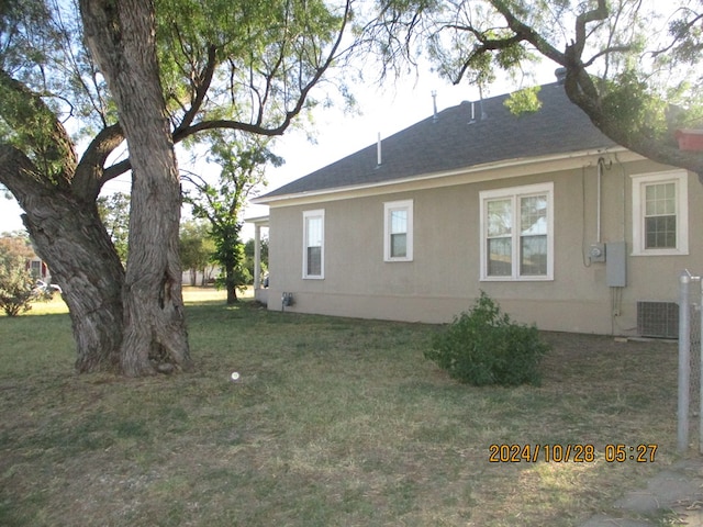 view of home's exterior featuring a lawn and central air condition unit